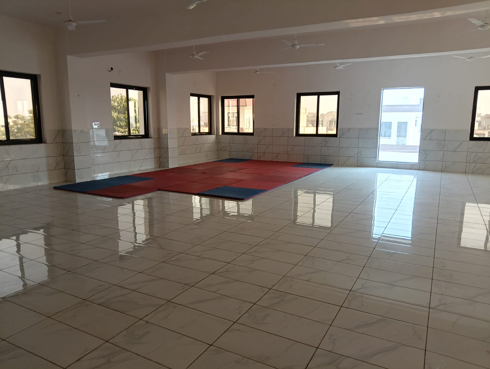 Spacious activity hall with exercise mats