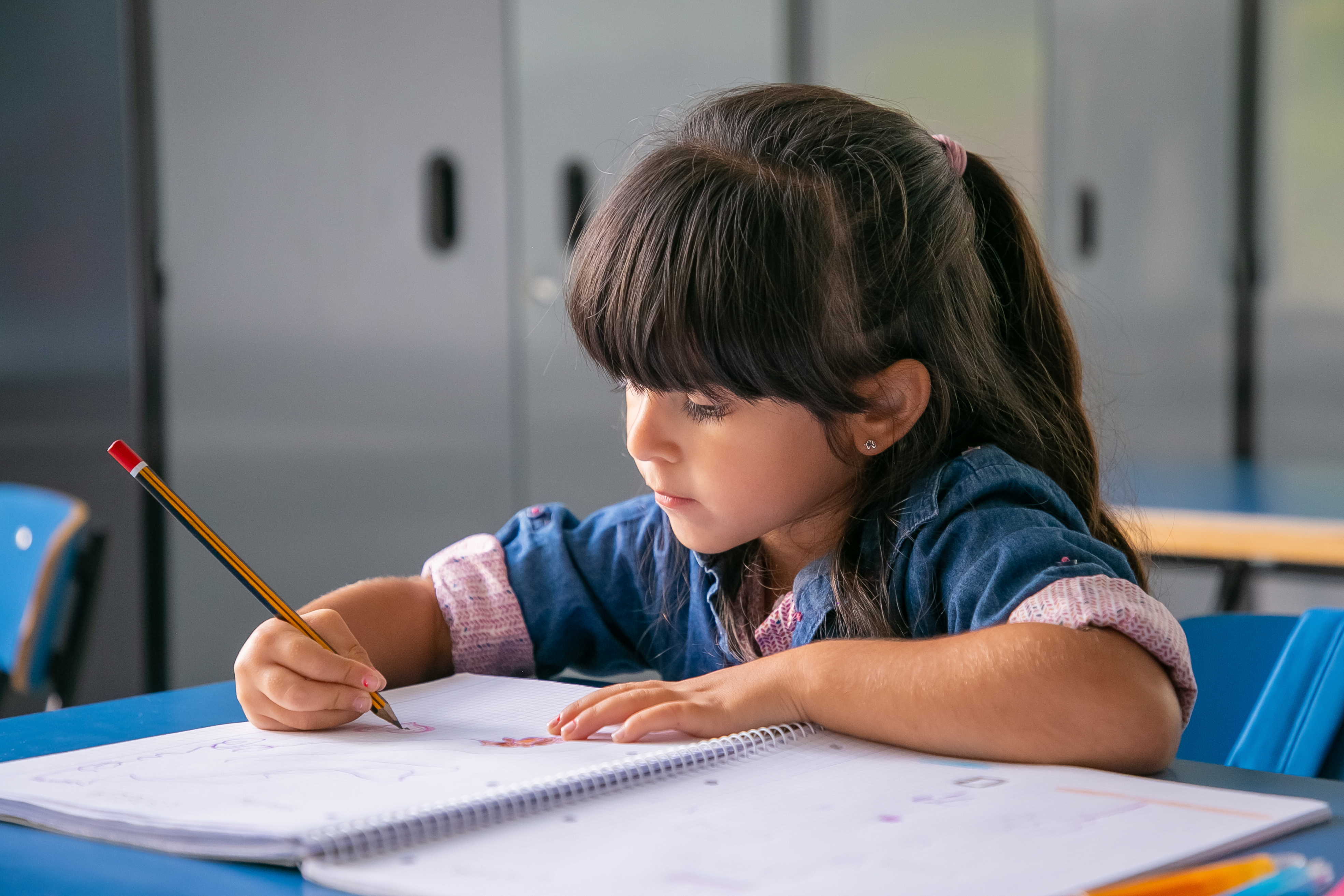 A child focused on sensory learning tools